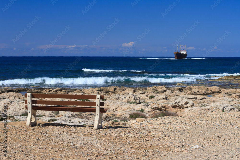 A wooden bench near the sea on the beach