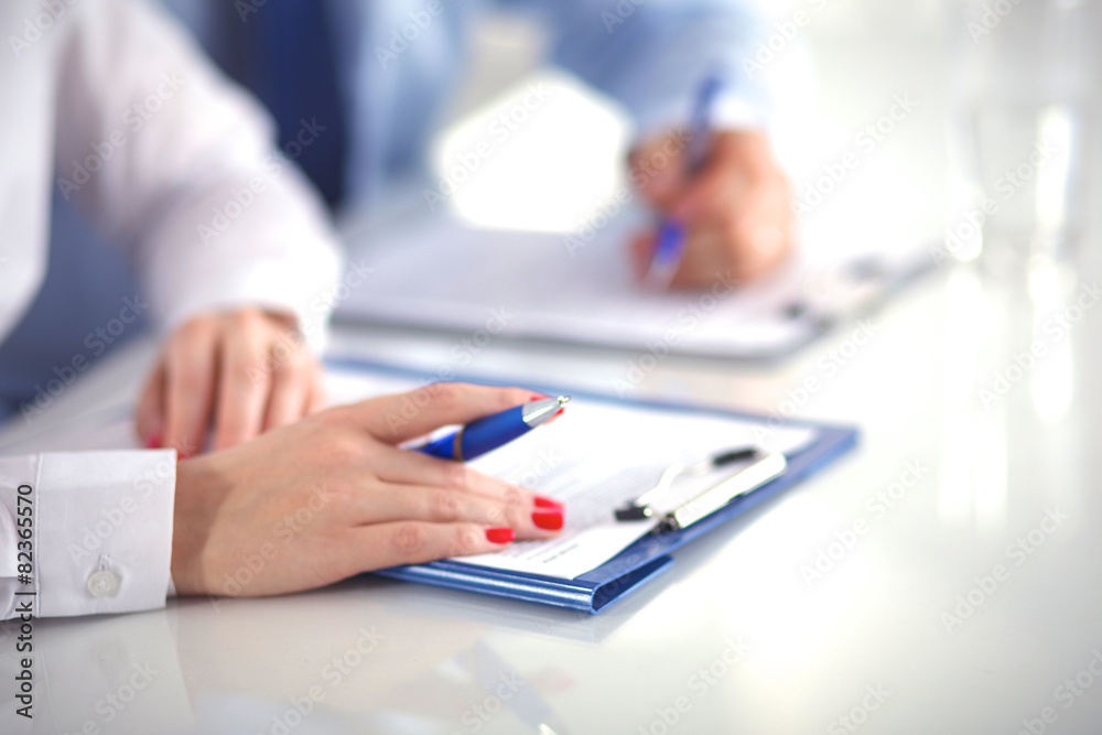 Image of business team sitting at the table and discussing a new Image of business team sitting at the table and discussing a new