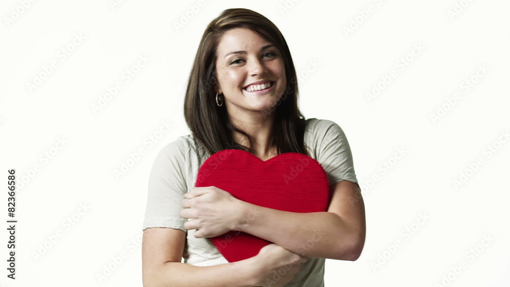 MS Portrait of young woman with gift box against white background / Orem, Utah, USA MS Portrait of young woman with gift box against white background / Orem, Utah, USA