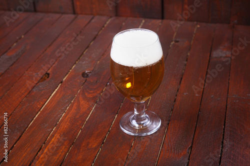 Glass of beer on wood