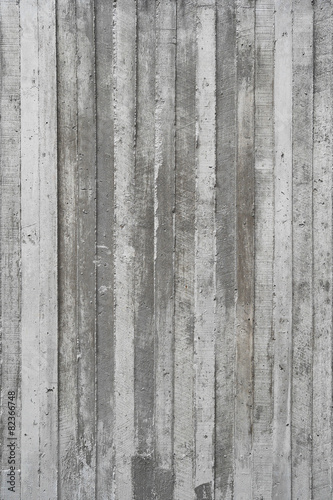 texture of wooden formwork stamped on a raw concrete wall as bac