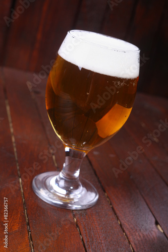 Glass of beer on wood