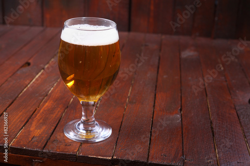 Glass of beer on wood