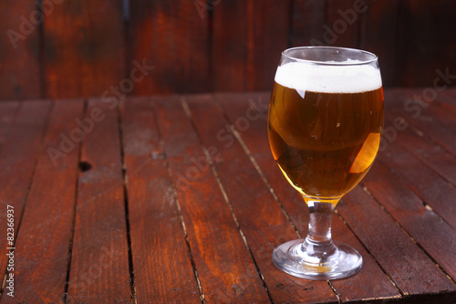 Glass of beer on wood
