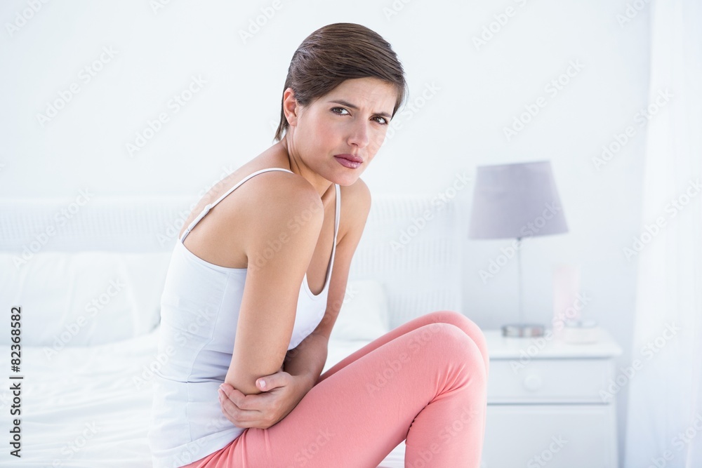 Beautiful brunette suffering from stomach pain Beautiful brunette suffering from stomach pain