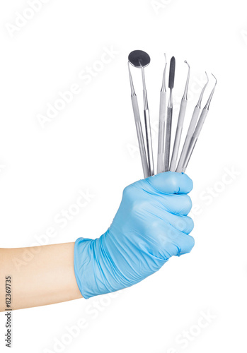 hands holding dental instruments