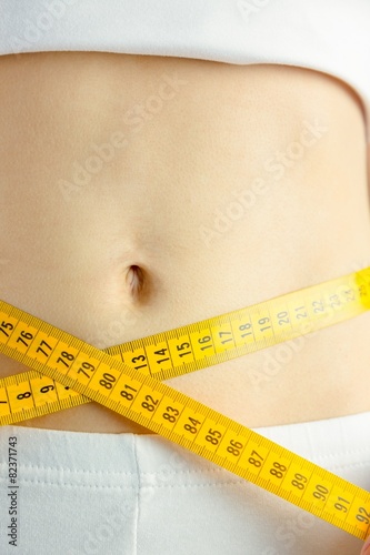 Slim woman measuring her waist