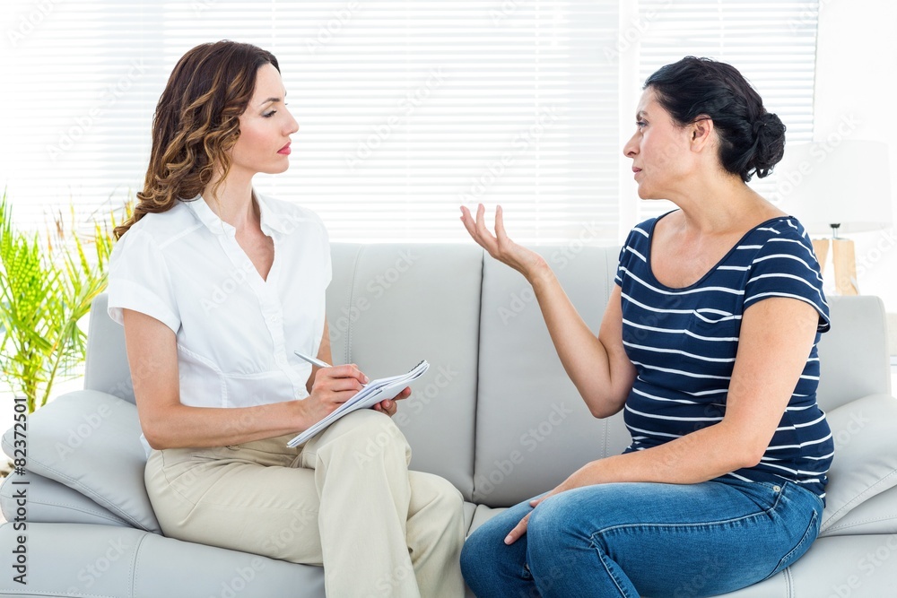 Depressed woman talking with her therapist Depressed woman talking with her therapist