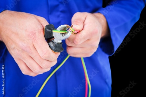 Composite image of electrician cutting wire with pliers