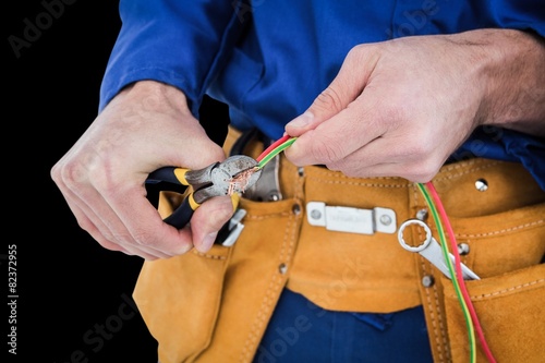 Composite image of electrician cutting wires