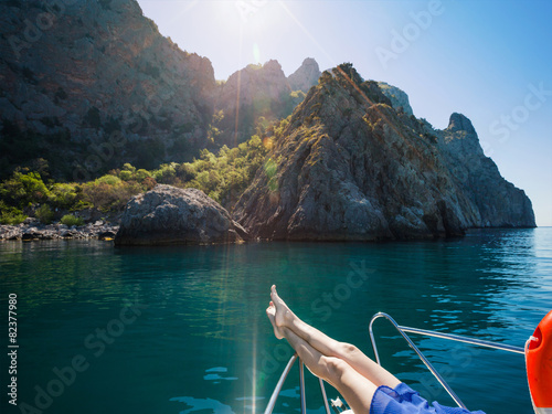 Female feet on the boat. Leisure activities on yacht at sea.