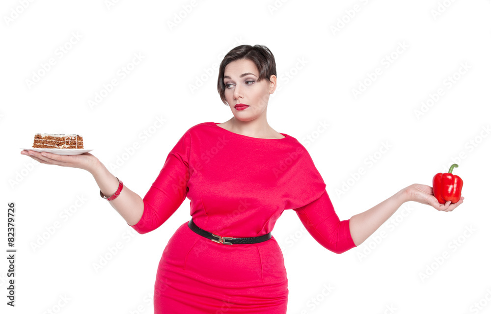 Plus size woman making choice between healthy and unhealthy food Plus size woman making choice between healthy and unhealthy food