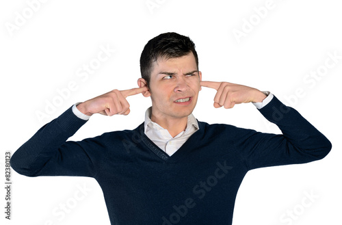 Young man cover ears