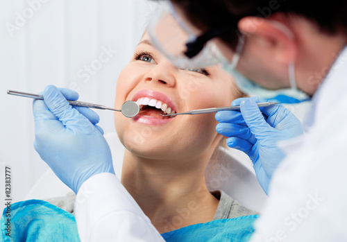 Dental cure. Molar treatment. Young female patient at dentist