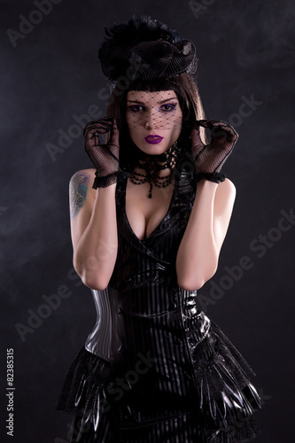 Sensual gothic girl in hat with veil