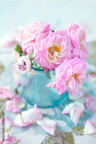 Close-up floral composition with a pink roses .