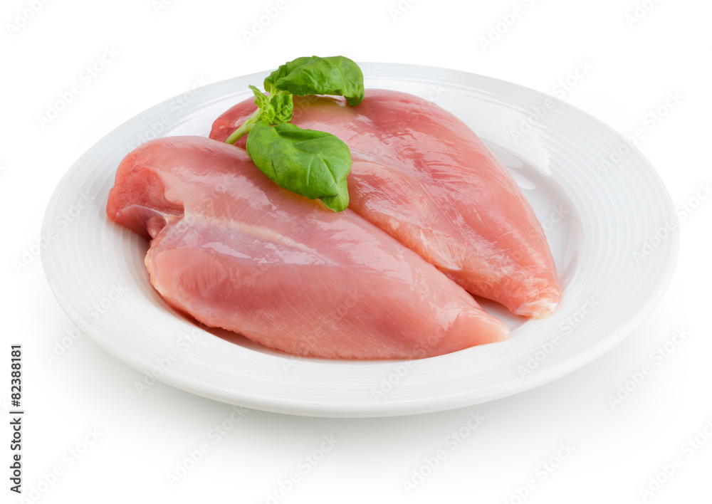 Raw chicken fillets on white plate isolated. With clipping path. Raw chicken fillets on white plate isolated. With clipping path.