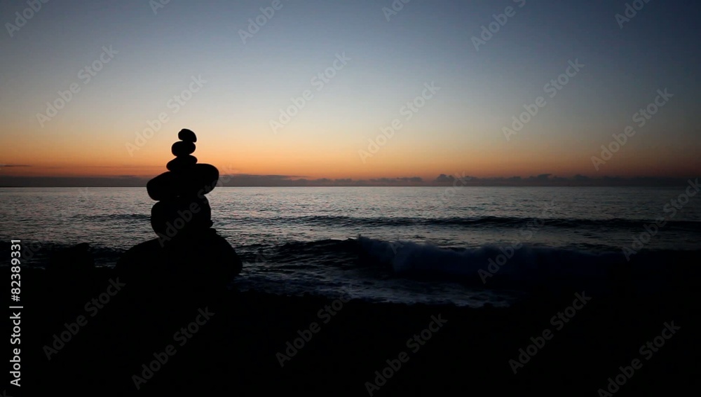 Sunset ocean / beach , red sky, stacked stone pyramid Sunset ocean / beach , red sky, stacked stone pyramid