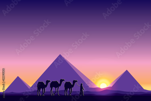 Egypt Great Pyramids with Camel caravan on sunset background