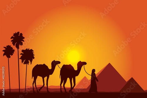 Egypt Great Pyramids with Camel caravan on sunset background