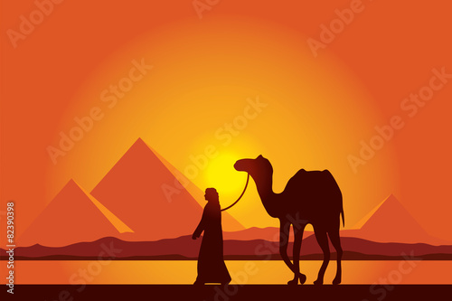 Egypt Great Pyramids with Camel caravan on sunset background