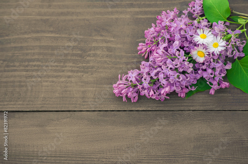 Fototapeta Naklejka Na Ścianę i Meble -  Colorful lilac  flowers on wooden background