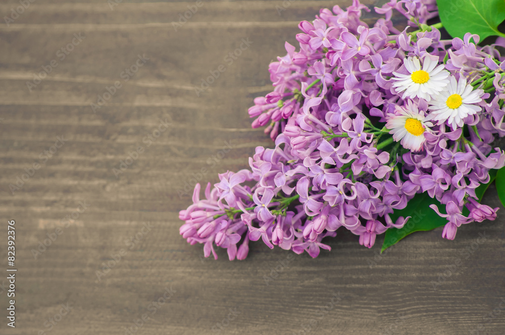 Colorful lilac  flowers on wooden background