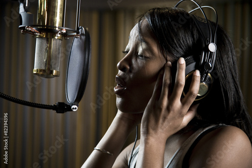 Woman singing in recording studio