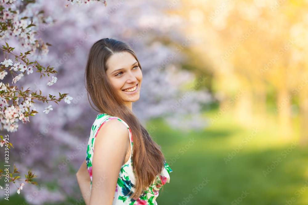 Beautiful brunette woman in blooming orchard Beautiful brunette woman in blooming orchard