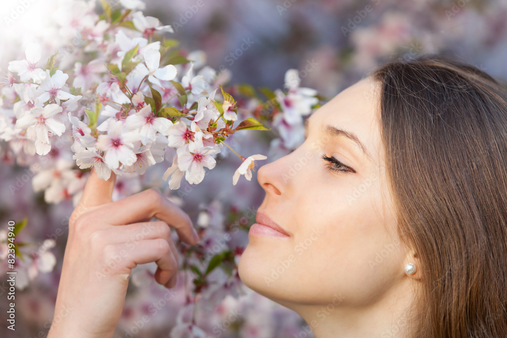 Beautiful brunette woman in blooming orchard Beautiful brunette woman in blooming orchard