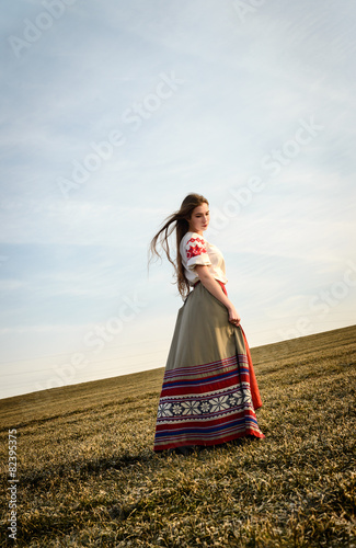young woman in Slavic Belarusian national original suit outdoors