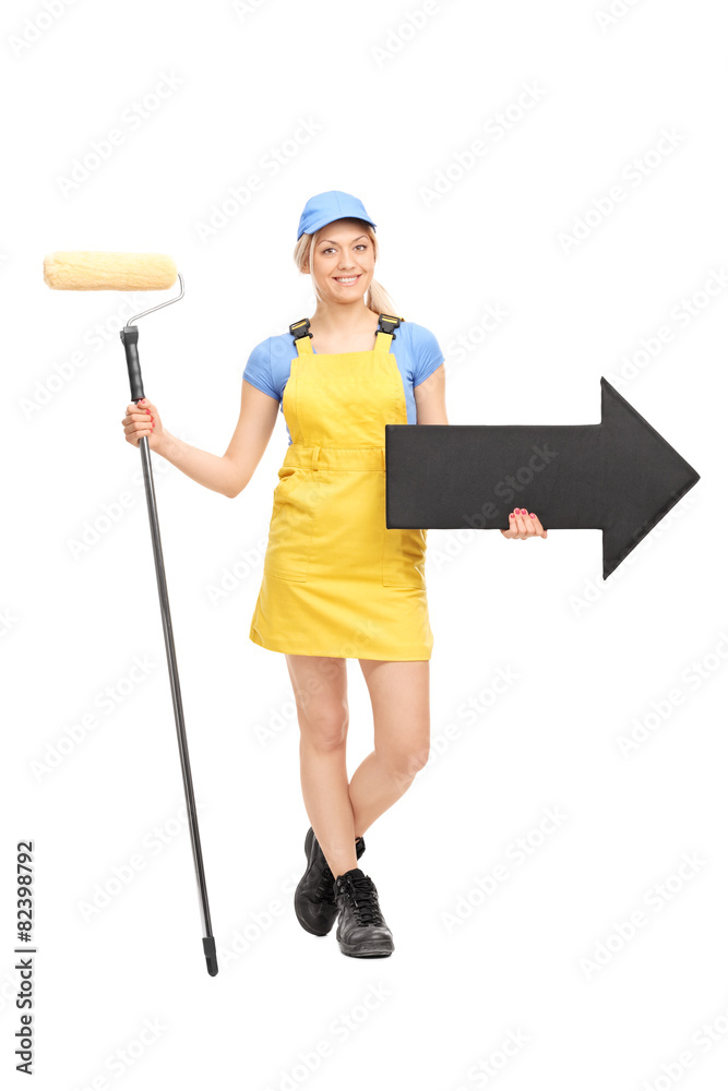 Female painter holding a paint roller and an arrow Female painter holding a paint roller and an arrow
