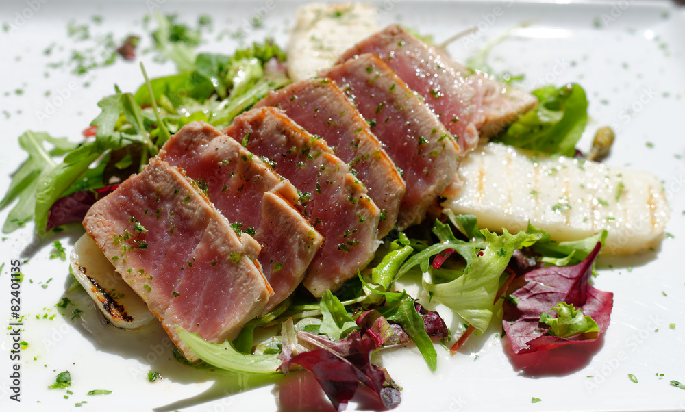 Appetizing slightly roasted tuna on a salad Appetizing slightly roasted tuna on a salad