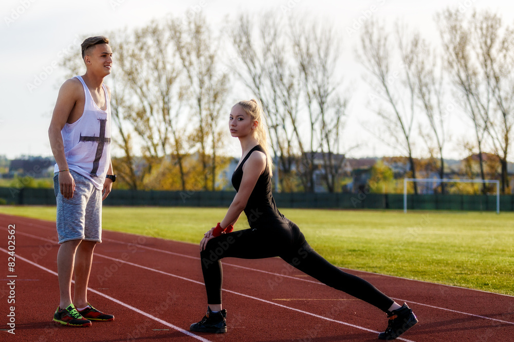 young health couple doing stretching exercise relaxing and warm