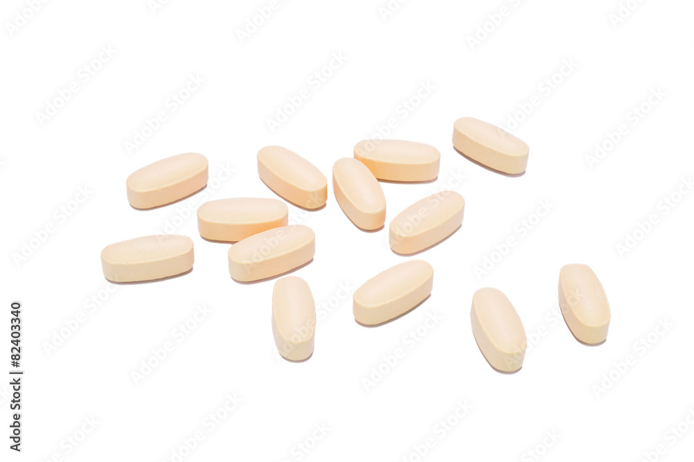 Heap of orange round medicine tablet pills