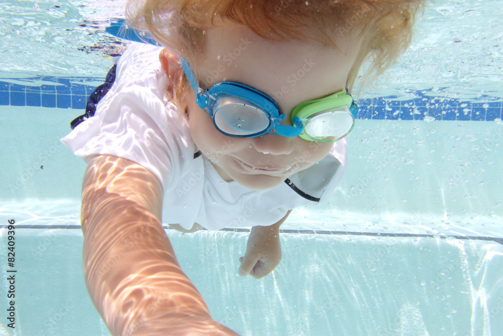 Child Swimming in Pool Underwater