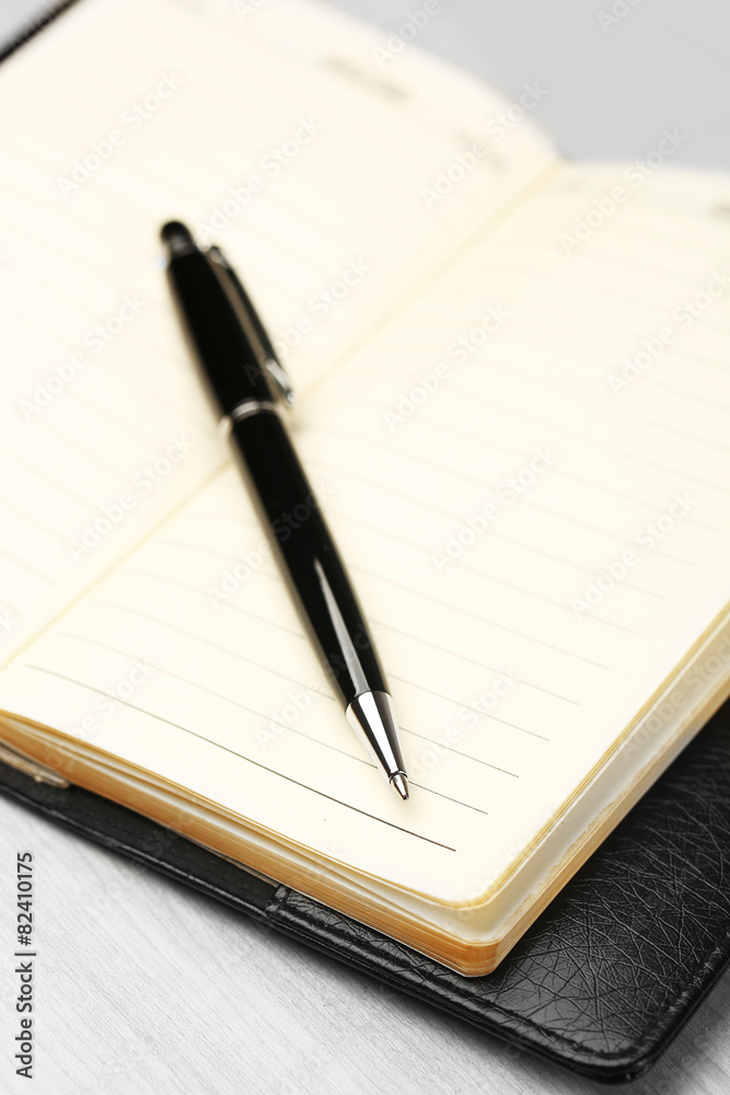 Writing pen and notebook on wooden table, closeup Writing pen and notebook on wooden table, closeup