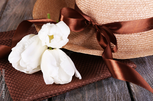 Hat with flowers on wooden background, closeup © Africa Studio