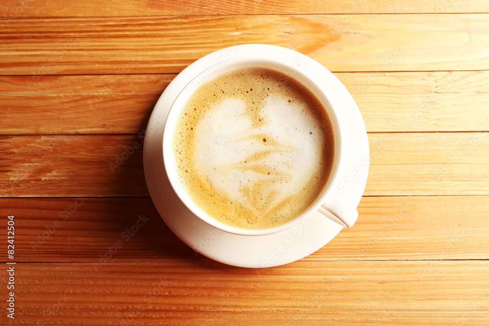 Cup of coffee latte art on wooden table, top view Cup of coffee latte art on wooden table, top view