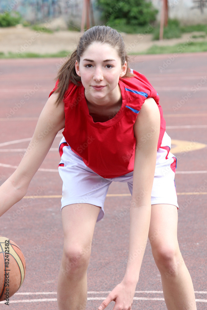 teenager playing a basketball