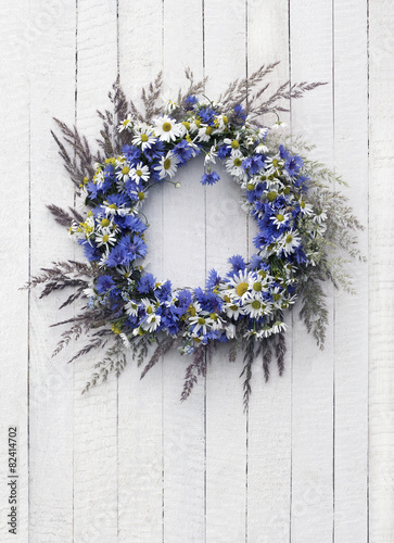 Wreath of flowers on the wooden background photo