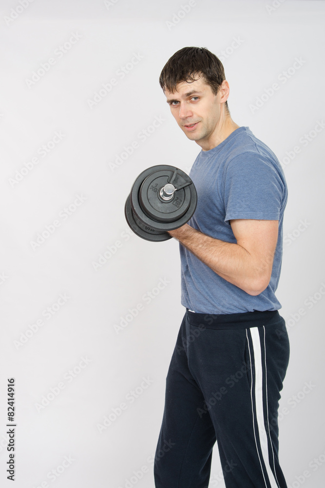Portrait of an athlete with a dumbbell in your left hand Portrait of an athlete with a dumbbell in your left hand
