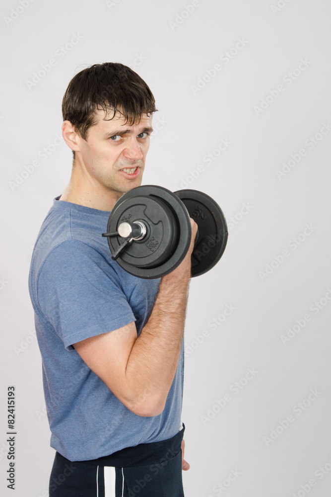Tired athlete with dumbbells