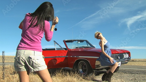 women taking pictures on the side of the road