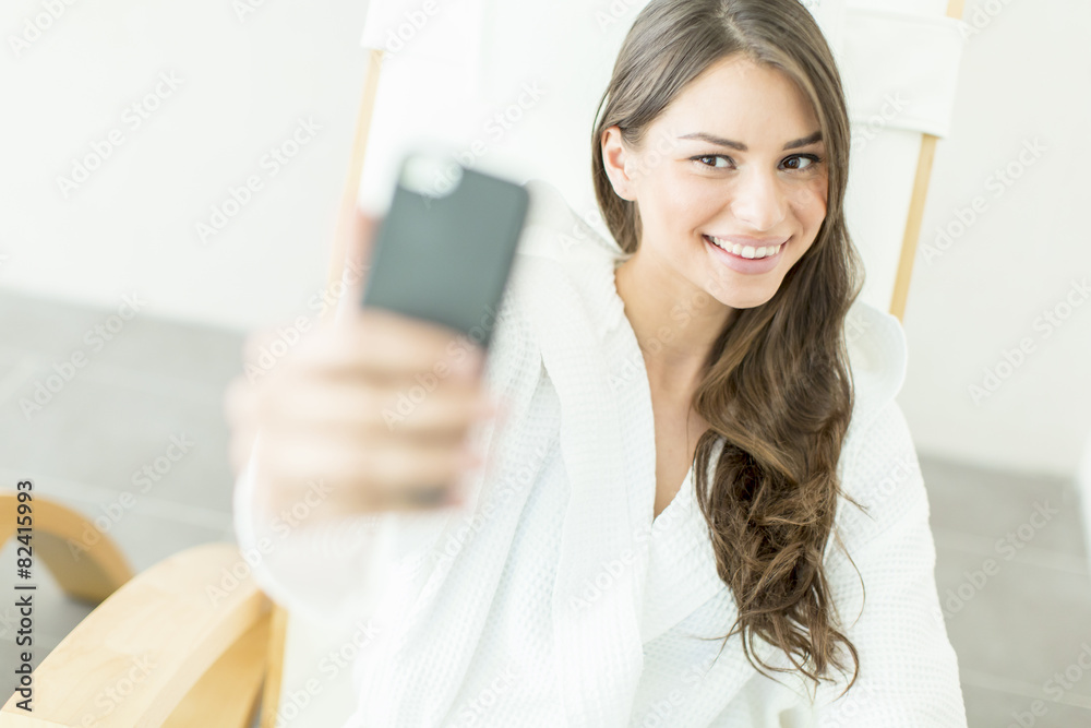 Young woman taking selfie with mobile phone