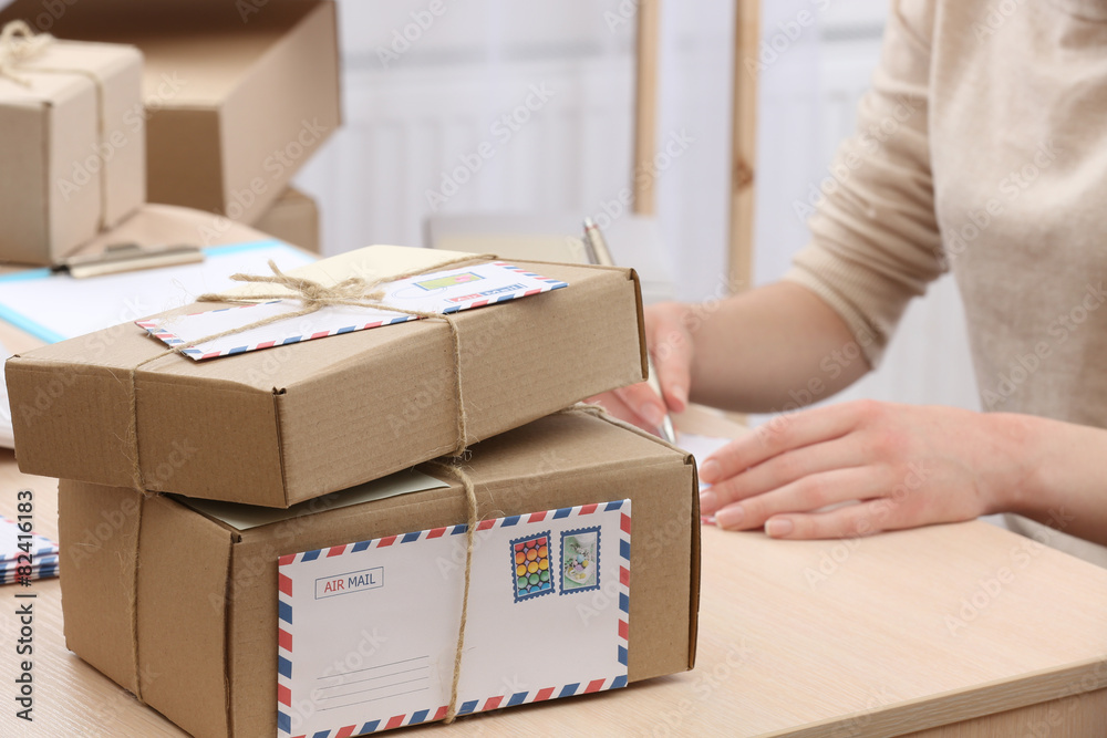 Cardboard boxes on work place in post office Stock Photo | Adobe Stock
