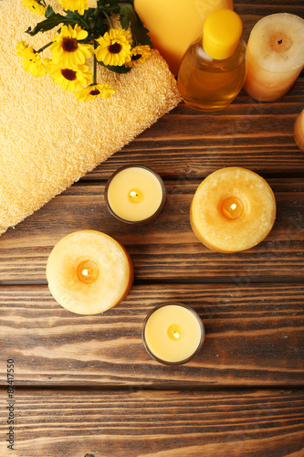 Soft towel with candles on table close up