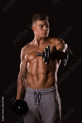 muscular man bodybuilder lifting weight