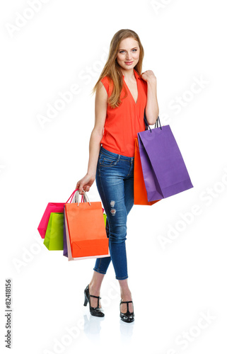 Happy lovely woman with shopping bags over white