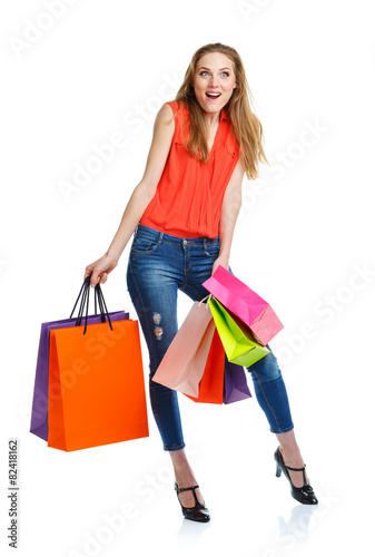 Happy lovely woman with shopping bags over white
